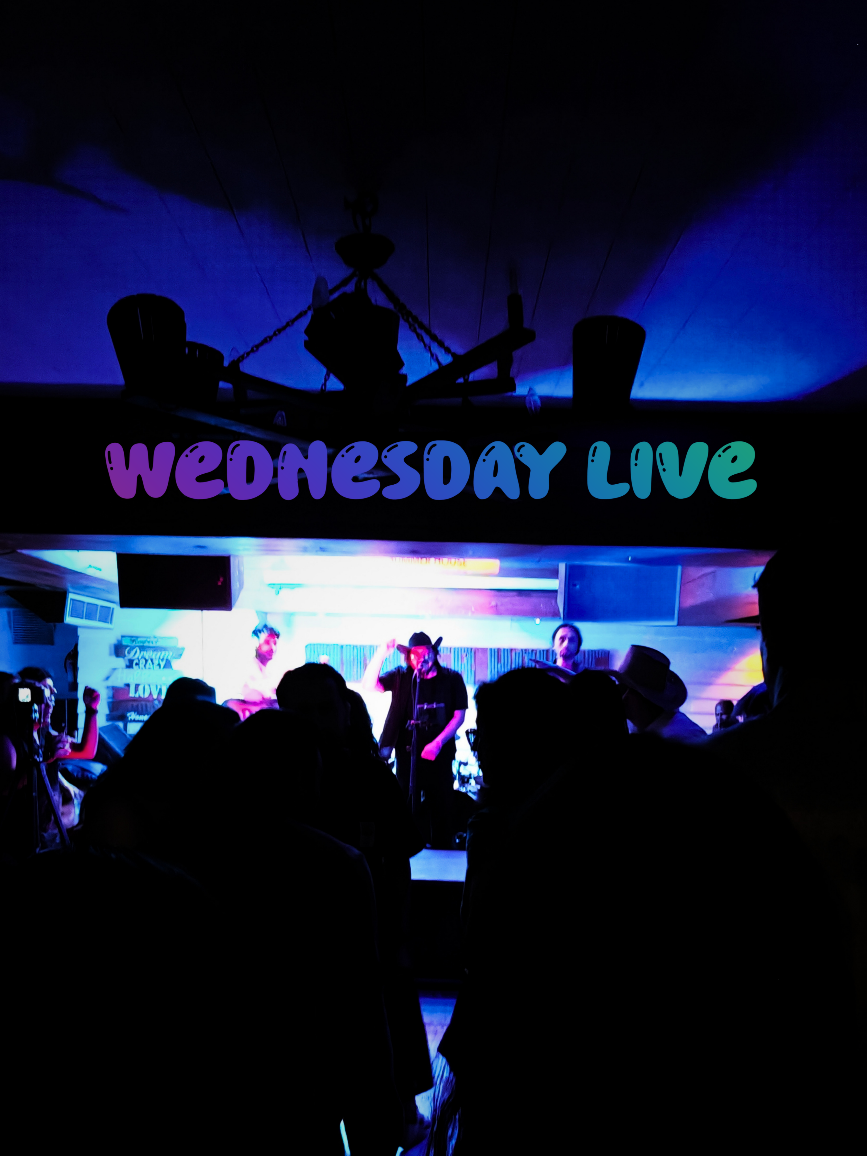 Crowd with raised hands at a live music night